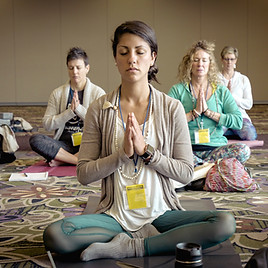 People meditating together in a hall