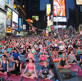 A crowd meditating together in Times Square